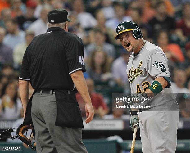 Billy Butler of the Oakland Athletics argues with home plate umpire Tim Welke after being called out on strikes in the third inning against the...