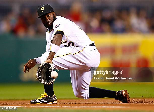 Josh Harrison of the Pittsburgh Pirates fields a ground ball down the third base line in the ninth inning against the Detroit Tigers while wearing...