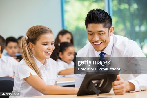 A Tutor Using Technology Teacher Showing Student How To Use Technology High-Res Stock Photo ...