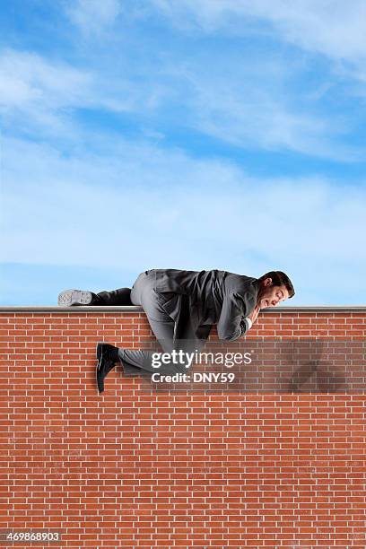 climbing over a wall - suits hanging stock pictures, royalty-free photos & images