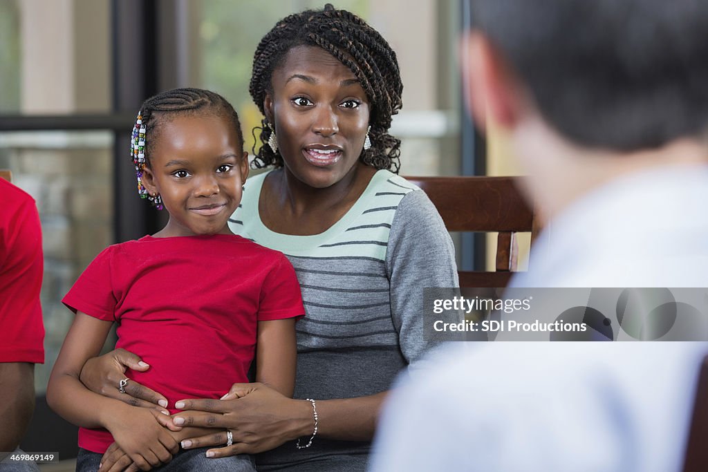 Mother and daughter talking with counselor during family counseling session