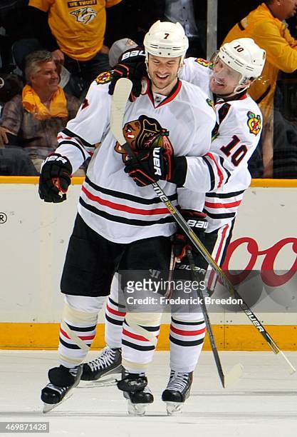 Patrick Sharp of the Chicago Blackhawks hugs teammate Brent Seabrook after defeating of the Nashville Predators in the second overtime period of Game...