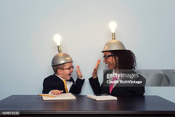 business team celebrates wearing mind reading helmets - kid making money stock pictures, royalty-free photos & images