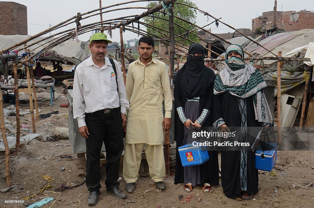 The Pakistani Polio Vaccination Team administers polio drops...
