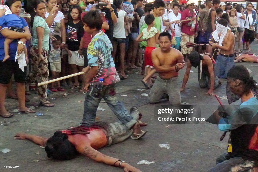 A teenage boy, leads the punishing of the flagellants by...