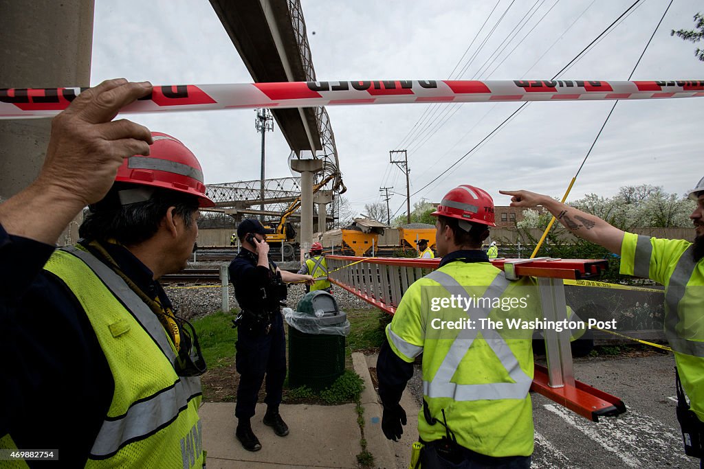 COLLEGE PARK, MD - APRIL 15: Workers evaluate the scene where a