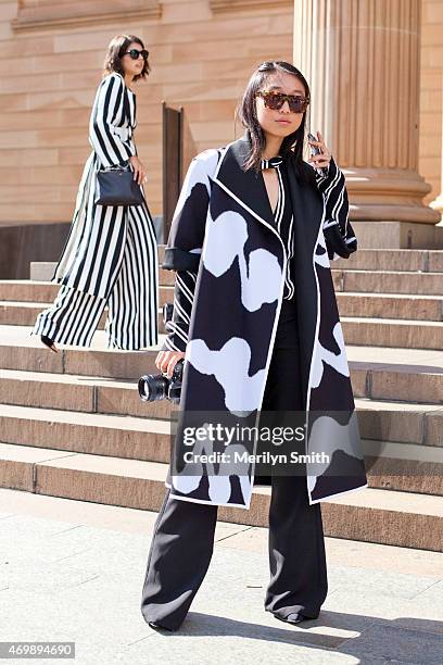 Fashion Blogger Margaret Zhang wears a Bec and Bridge coat and Pare sunglasses at Mercedes-Benz Fashion Week Australia 2015 at Carriageworks on April...