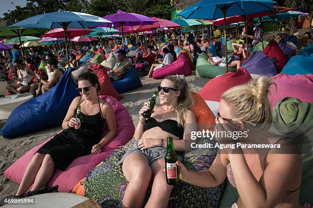 Tourists drink Bintang beers at Double Six beach on April 16, 2015 in Seminyak, Bali, Indonesia. Indonesia, on April 16, banned small retailers from...