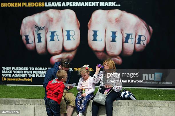 An advertisement van with the words 'Liar Liar' emblazoned on the side drives around Parliament Square on April 16, 2015 in London, England. The vans...