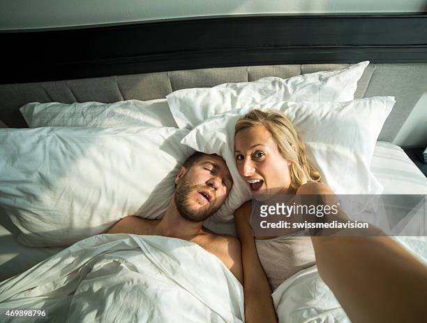 girlfriend takes selfie of boyfriend sleeping in bed - teasing stock pictures, royalty-free photos & images
