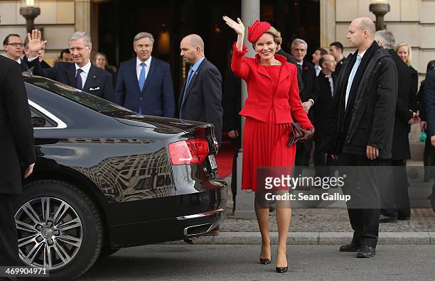 Queen Mathilde of Belgium and King Philippe of Belgium wave to onlookers as they depart the Adlon Hotel as Berlin Mayor Klaus Wowreit looks on on...