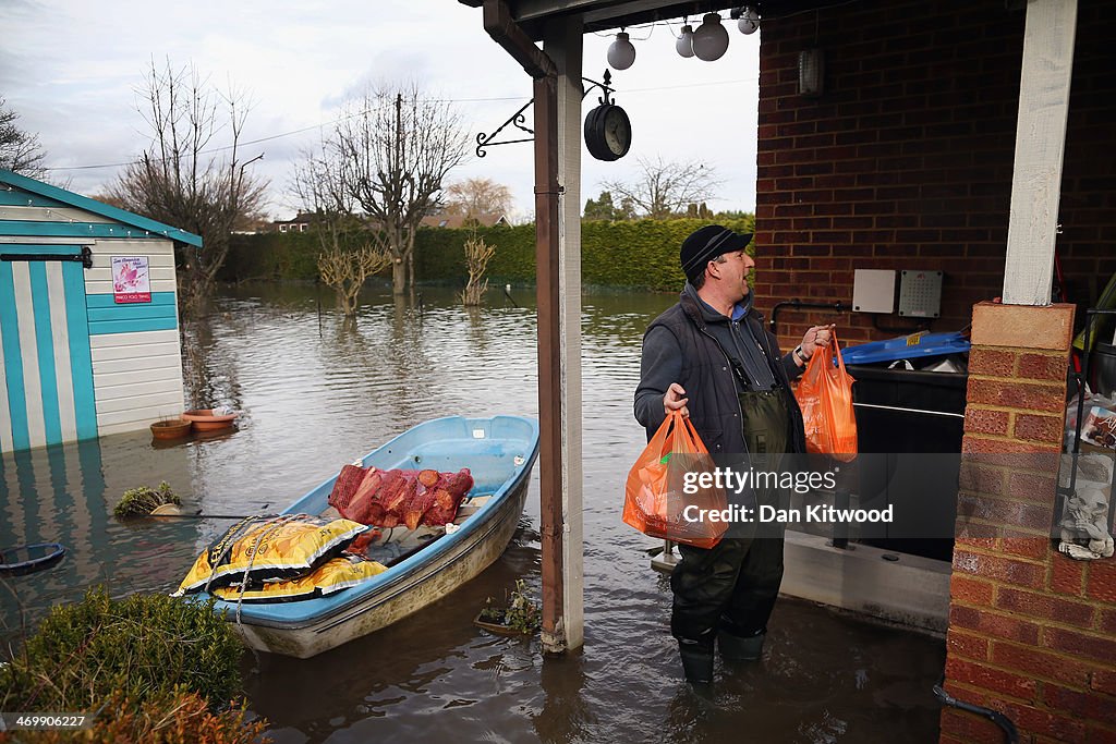 Residents Assess The Damage Of Their Flood Hit Homes And Businesses