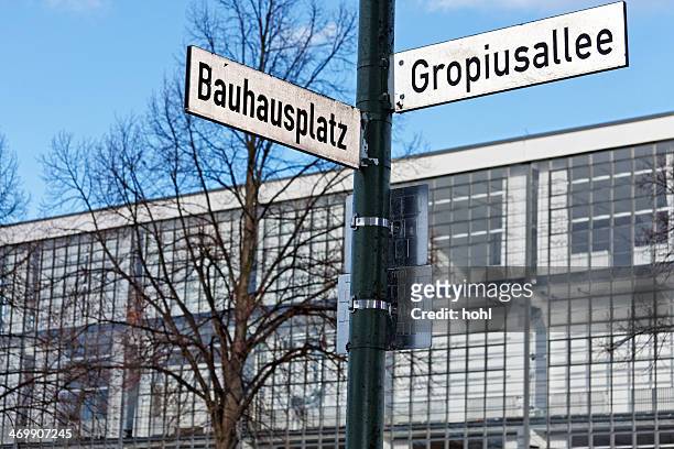 bauhaus dessau facade with street name sign - baumhaus stock pictures, royalty-free photos & images