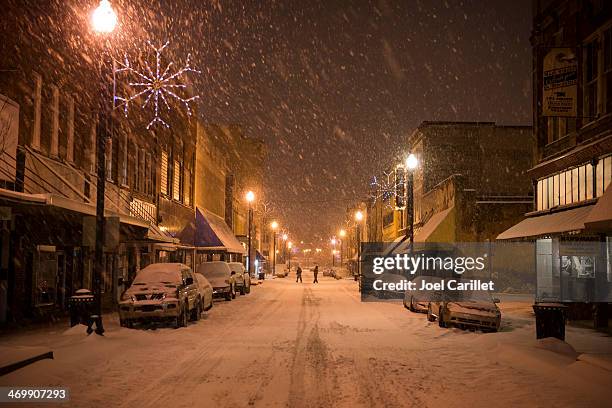 snowy night on main street - small town america stock pictures, royalty-free photos & images
