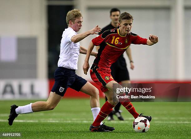 Matisse Thuys of Belgium holds off pressure from Tom Davies of England during a U16 International match between England and Belgium at St Georges...