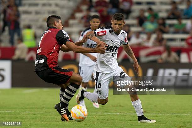 Luis Venegas of Atlas fights for the ball with Carlos Carvalho of Atletico Mineiro during a match between Atlas and Atletico Mineiro as part of Copa...