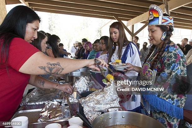 People are served native dishes at the annual traditional agave roast at the Malki Museum on the Morongo Indian Reservation near Banning, California,...