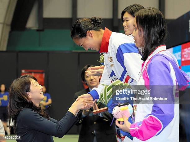Kanako Watanabe shakes hands with Barcelona Olympic gold medalist Kyoko Iwasaki on the podium after winning the Women's 200m Breaststroke final...