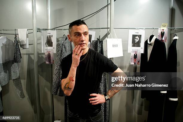 David Delfin prepares backstage before his fashion show during the Mercedes Benz Fashion Week Winter/Fall Madrid 2014 at Ifema on February 17, 2014...