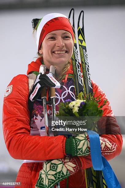 Gold medalist Darya Domracheva of Belarus celebrates during the flower ceremony for the Women's 12.5 km Mass Start during day ten of the Sochi 2014...