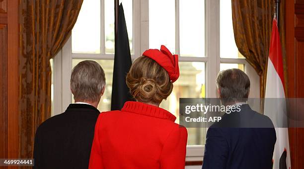 Belgian King Philippe, Queen Mathilde and Berlin's Mayor Klaus Wowereit look out of the window after signing the Golden Book of the city of Berlin at...