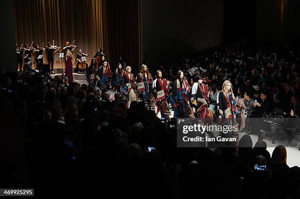 Model Cara Delevingne leads the finale on the the runway at Burberry Womenswear Autumn/Winter 2014 at Kensington Gardens on February 17, 2014 in...