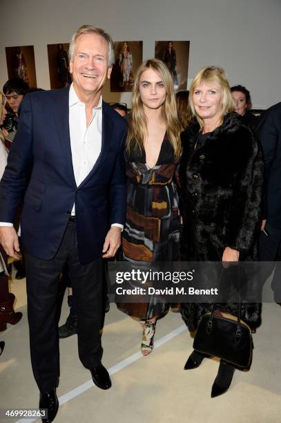 Cara Delevingne poses with parents Charles Delevingne and Pandora Delevingne attend the front row at Burberry Womenswear Autumn/Winter 2014 at...