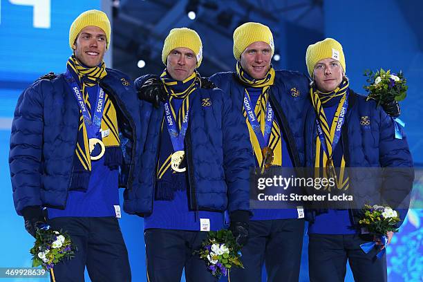 Gold medalists Marcus Hellner, Johan Olsson, Daniel Richardsson and Lars Nelson of Sweden celebrate on the podium during the medal ceremony for the...