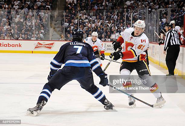 Brett Kulak of the Calgary Flames chases the play down the ice as Keaton Ellerby of the Winnipeg Jets defends during third period action on April 11,...