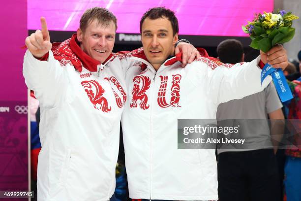 Gold medalists Alexander Zubkov and Alexey Voevoda of Russia team 1 celebrate during the flower ceremony for the Men's Two-Man Bobsleigh on Day 10 of...
