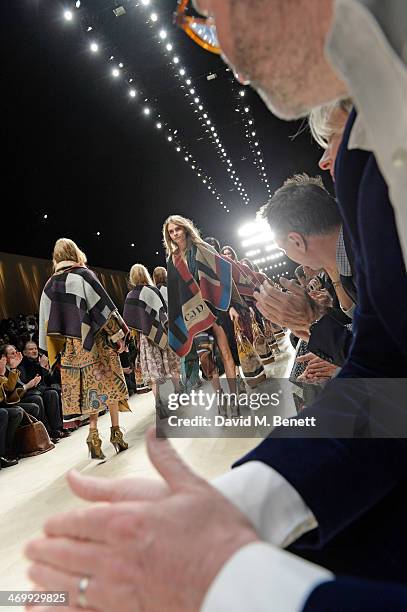 Cara Delevingne walks the runway at Burberry Womenswear Autumn/Winter 2014 at Kensington Gardens on February 17, 2014 in London, England.