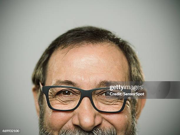 portrait of a happy caucasian man with glasses and beard. - smiling mature eyes stockfoto's en -beelden