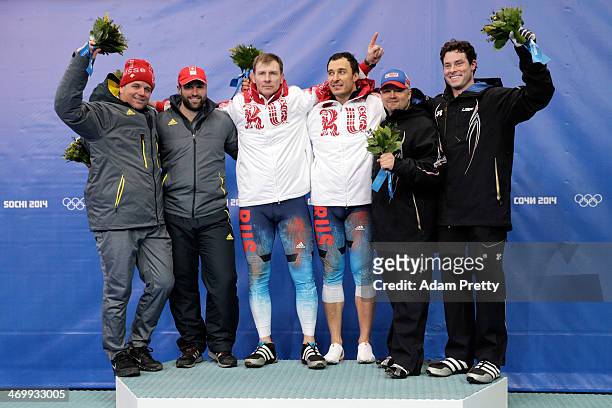 Silver medalists Beat Hefti and Alex Baumann of Switzerland team 1, gold medalists Alexander Zubkov and Alexey Voevoda of Russia team 1 and bronze...