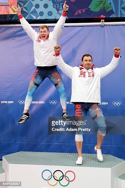 Gold medalists Alexander Zubkov and Alexey Voevoda of Russia team 1 celebrate during the flower ceremony for the Men's Two-Man Bobsleigh on Day 10 of...