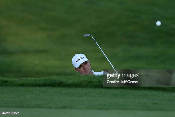 John Mallinger hits a bunker shot on the 14th hole in the first round of the Northern Trust Open at the Riviera Country Club on February 13, 2014 in...