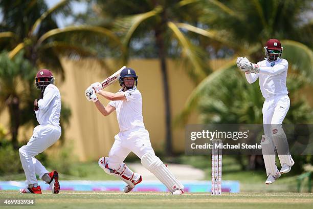 Gary Ballance of England plays to the offside as wicketkeeper Denesh Ramdin and Jermaine Blackwood look on during day four of the 1st Test match...