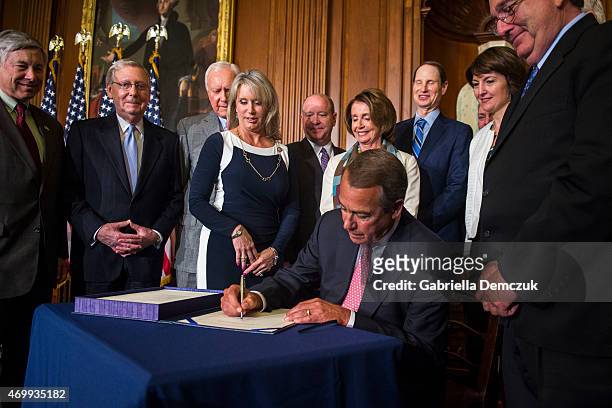 House Speaker John Boehner signs the Medicare Access CHIP Reauthorization Act 2015, H.R. 2, during a press event at the Capitol on April 16, 2015 in...