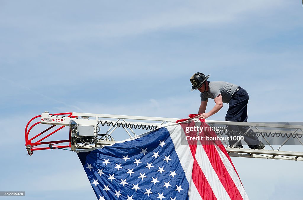 Fireman hanging a flag in a Patriotic Parade