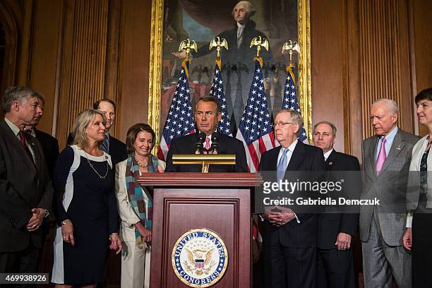 House Speaker John Boehner , flanked by House Minority Leader Nancy Pelosi and Senate Majority Leader Mitch McConnell , speaks at the bipartisan...