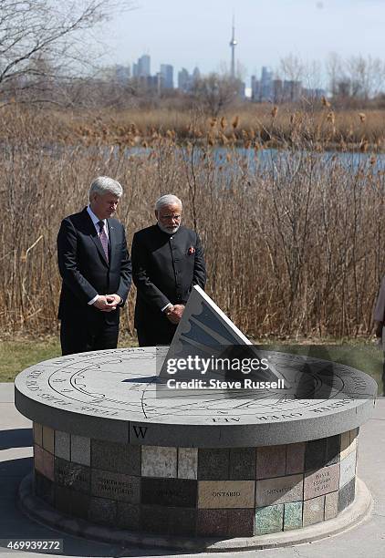 Indian Prime Minister Narendra Modi and Prime Minister Stephen Harper take in the monument after laying wreaths during a visit to the Air India...