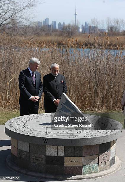 Indian Prime Minister Narendra Modi and Prime Minister Stephen Harper take in the monument after laying wreaths during a visit to the Air India...
