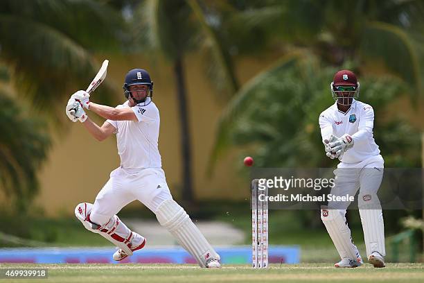 Gary Ballance of England plays to the offside as wicketkeeper Denesh Ramdin looks on during day four of the 1st Test match between West Indies and...