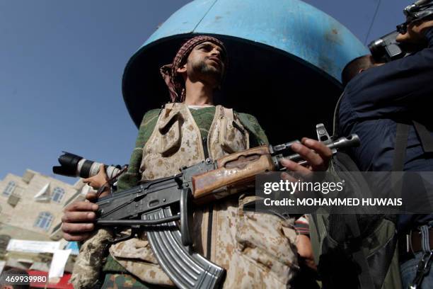 Tribal gunman loyal to the Shiite Huthi movement holds his weapon on April 16, 2015 in the capital Sanaa during a demonstration against the decision...