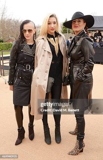 Donna Grantis, Hannah Welton, Ida Nielsen of 3RDEYEGIRL arrive at Burberry Womenswear Autumn/Winter 2014 at Kensington Gardens on February 17, 2014...