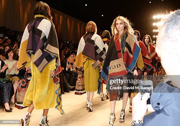 Cara Delevingne walks the runway at Burberry Womenswear Autumn/Winter 2014 at Kensington Gardens on February 17, 2014 in London, England.