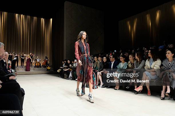 Paloma Faith performs as a model walks the runway at Burberry Womenswear Autumn/Winter 2014 at Kensington Gardens on February 17, 2014 in London,...