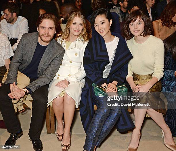 Daniel Bruhl, Melanie Laurent, Guey Lun-Mei and Felicity Jones attend the front row at Burberry Womenswear Autumn/Winter 2014 at Kensington Gardens...