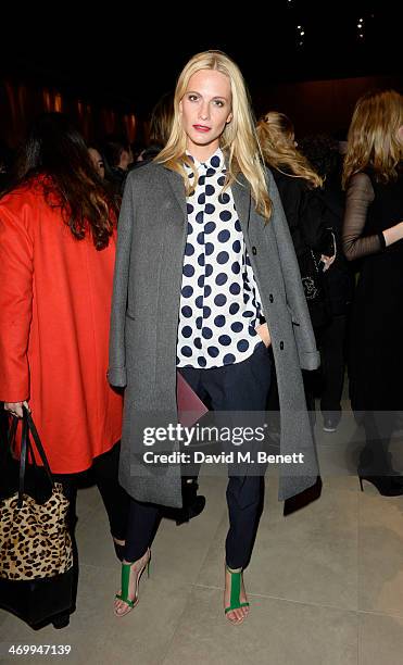 Poppy Delevingne attends the front row at Burberry Womenswear Autumn/Winter 2014 at Kensington Gardens on February 17, 2014 in London, England.