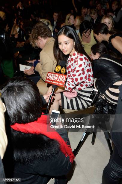 Angelababy gives an interview from the front row at Burberry Womenswear Autumn/Winter 2014 at Kensington Gardens on February 17, 2014 in London,...