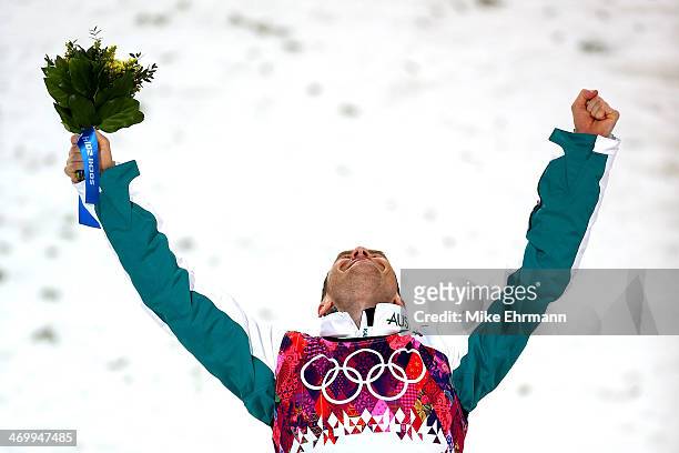 Silver medalist David Morris of Australia celebrates during the flower ceremony for the Freestyle Skiing Men's Aerials Finals on day ten of the 2014...